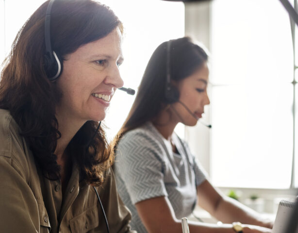 Two women in customer service roles helping customers